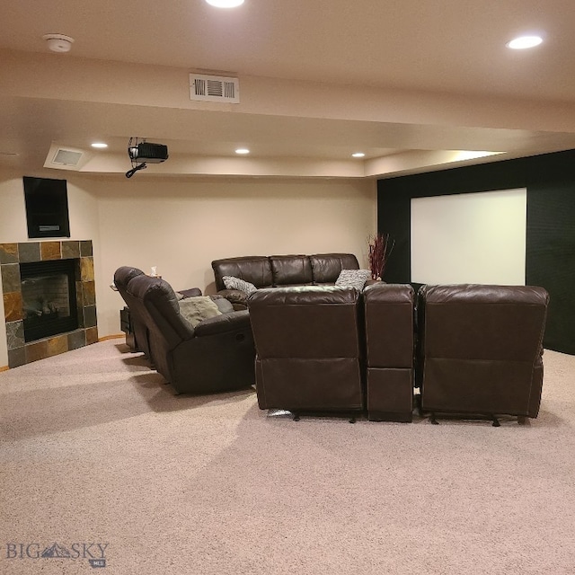 carpeted cinema room featuring a fireplace