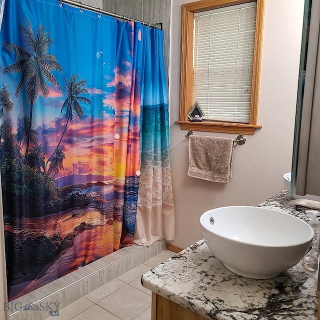 bathroom featuring tile patterned flooring, curtained shower, and sink