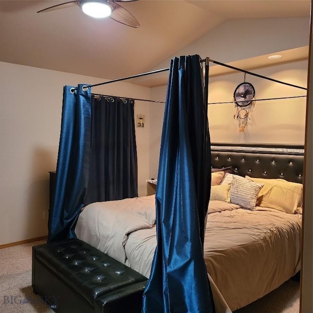 carpeted bedroom with ceiling fan and vaulted ceiling