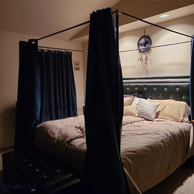 carpeted bedroom with vaulted ceiling