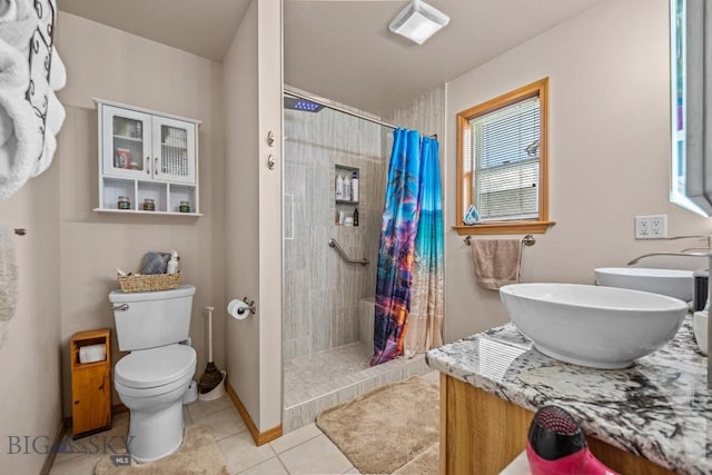 1311 Cruiser Ln, Belgrade, MT 59714 - full bath with double vanity, tile patterned flooring, and tiled shower