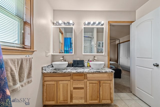 1311 Cruiser Ln, Belgrade, MT 59714 - bathroom featuring double vanity and tile patterned flooring