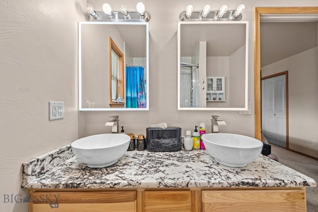 1311 Cruiser Ln, Belgrade, MT 59714 - bathroom featuring double vanity and an enclosed shower