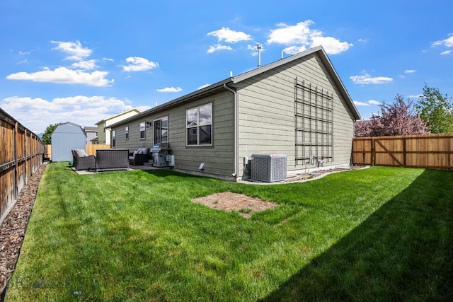 1311 Cruiser Ln, Belgrade, MT 59714 - rear view of house with outdoor lounge area, a storage unit, and a fenced backyard