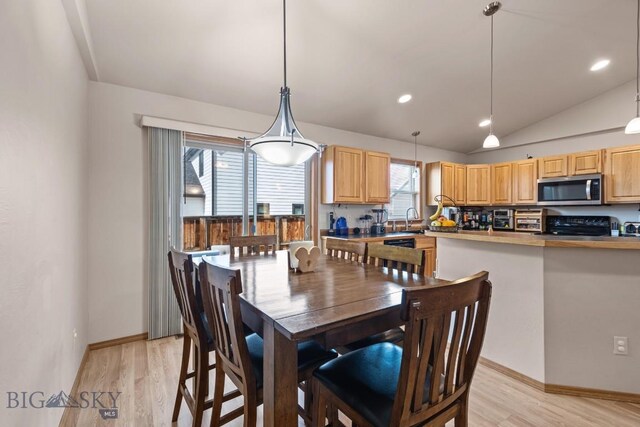 1311 Cruiser Ln, Belgrade, MT 59714 - dining space with light wood-style flooring, vaulted ceiling, and recessed lighting