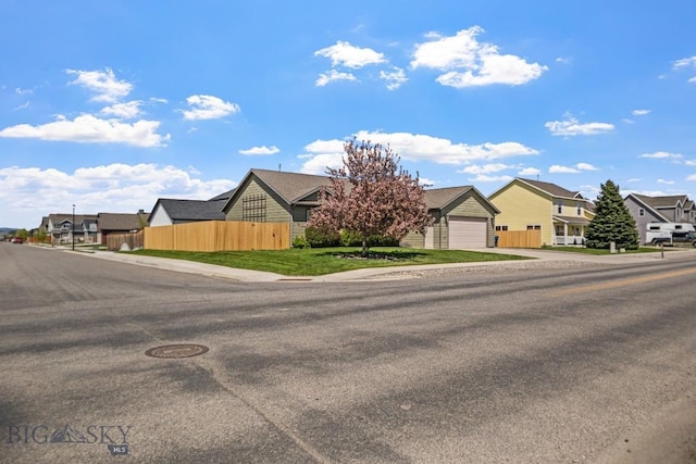 1311 Cruiser Ln, Belgrade, MT 59714 - view of property hidden behind natural elements featuring a residential view, concrete driveway, and a garage