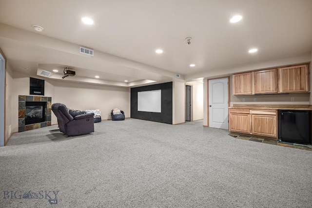 1311 Cruiser Ln, Belgrade, MT 59714 - carpeted home theater featuring a tile fireplace and recessed lighting