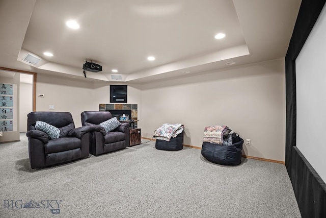 1311 Cruiser Ln, Belgrade, MT 59714 - carpeted home theater room featuring recessed lighting, a raised ceiling, and a tiled fireplace