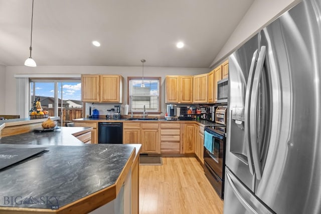 1311 Cruiser Ln, Belgrade, MT 59714 - kitchen with black appliances, dark countertops, light wood finished floors, light brown cabinetry, and vaulted ceiling
