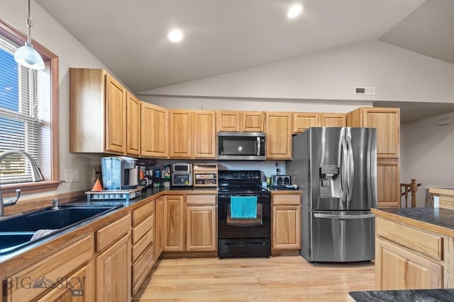 1311 Cruiser Ln, Belgrade, MT 59714 - kitchen featuring stainless steel appliances, lofted ceiling, dark countertops, light wood-style floors, and pendant lighting