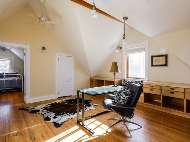 office space with ceiling fan, dark hardwood / wood-style flooring, and lofted ceiling