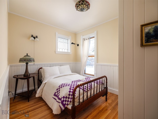 bedroom featuring wood-type flooring and ornamental molding