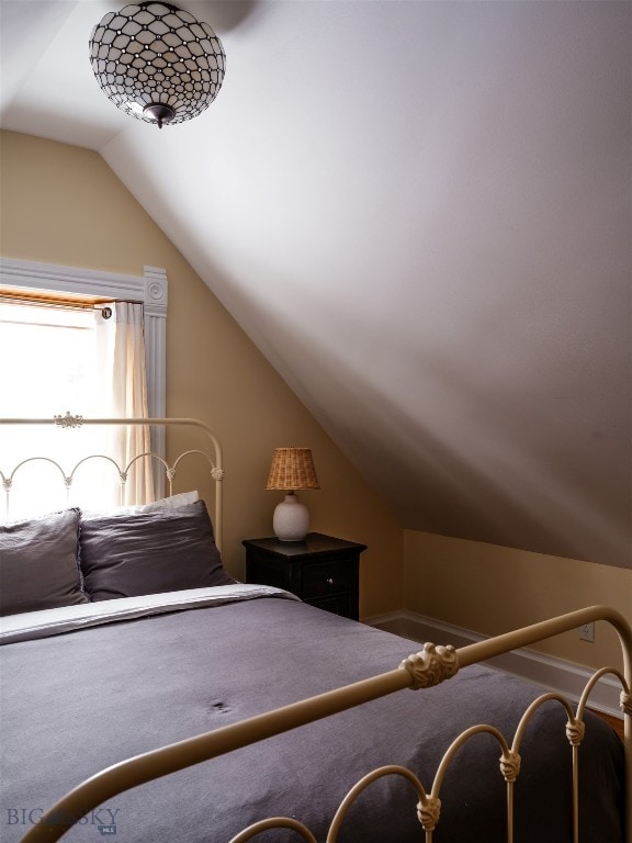 bedroom featuring vaulted ceiling