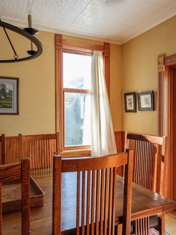 dining room featuring wood-type flooring and crown molding