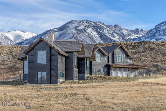 view of front of home with a mountain view and a garage