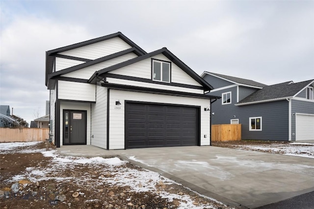 view of front facade featuring driveway and fence