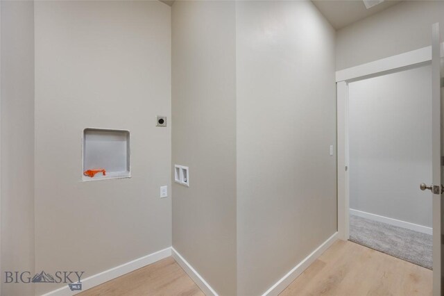 clothes washing area featuring washer hookup, hookup for an electric dryer, and light hardwood / wood-style flooring