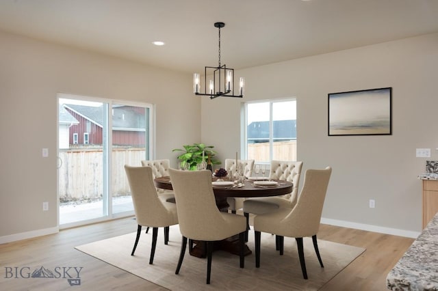 dining room featuring a notable chandelier, recessed lighting, light wood-style flooring, and baseboards