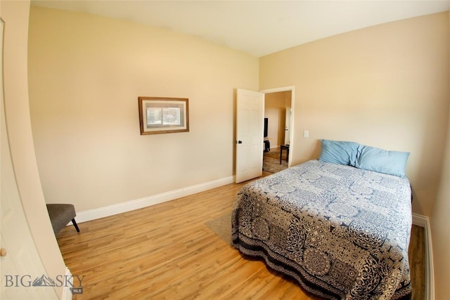 bedroom featuring baseboards and wood finished floors