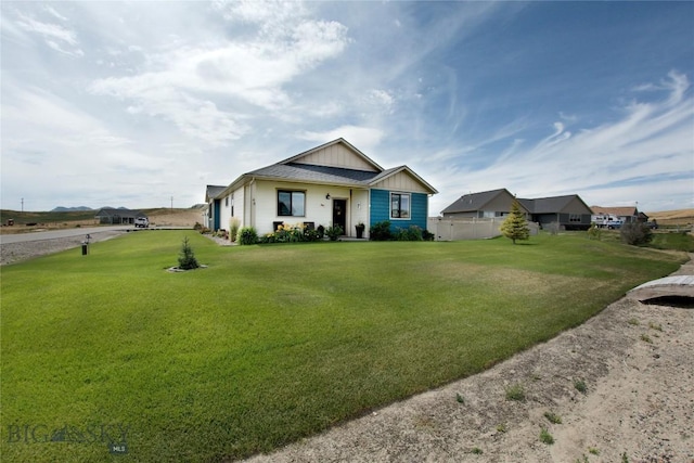 view of front facade with board and batten siding and a front yard