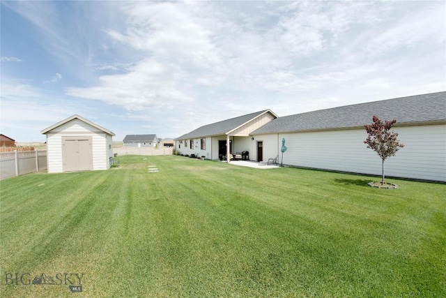 view of yard featuring a fenced backyard, a storage unit, a patio, and an outdoor structure