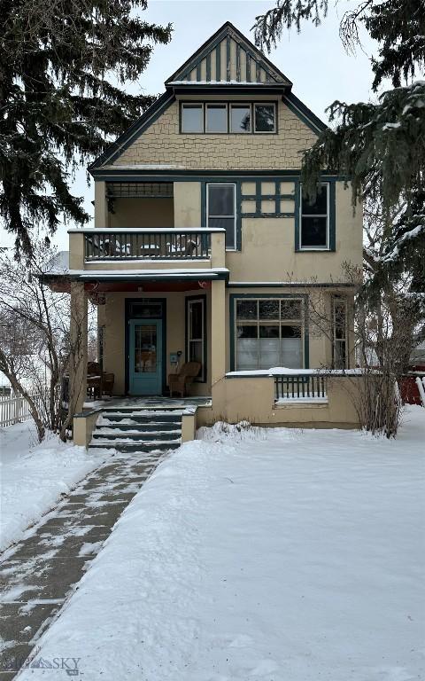 view of front of house with covered porch and a balcony