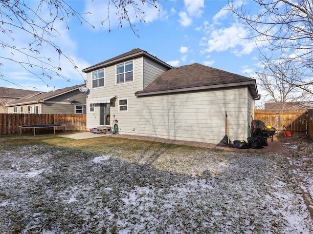 back of house featuring a patio area and a trampoline