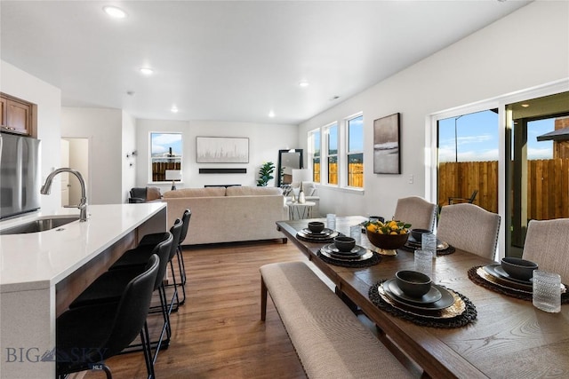 dining room with hardwood / wood-style floors and sink