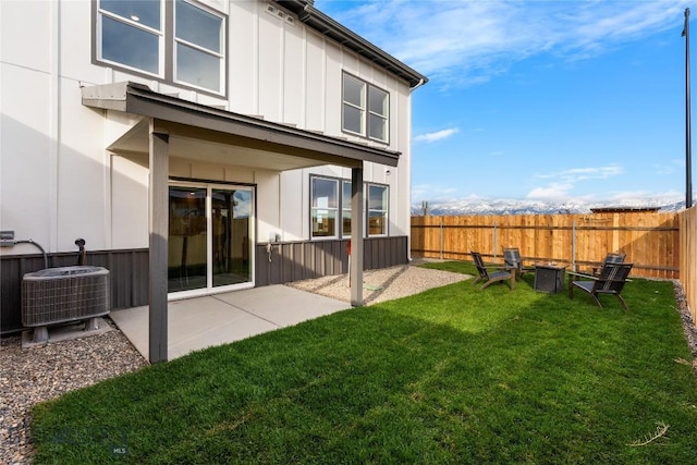 rear view of house featuring central air condition unit, a patio area, and a yard