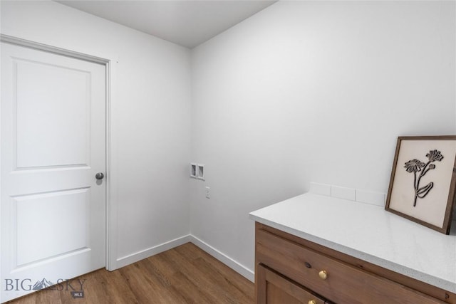 washroom with hookup for a washing machine and hardwood / wood-style floors