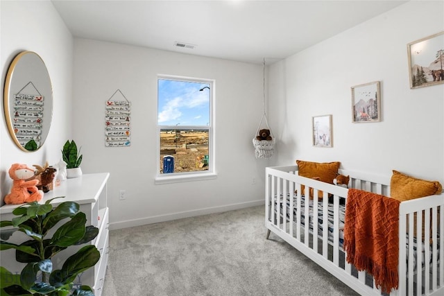 carpeted bedroom featuring a crib