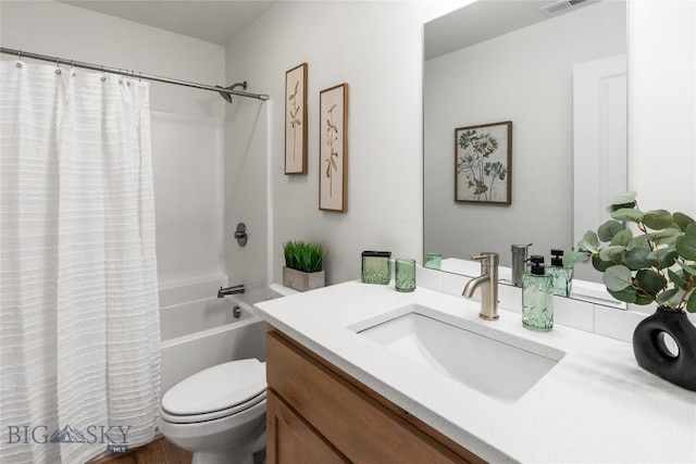 full bathroom with vanity, toilet, and shower / bath combo with shower curtain