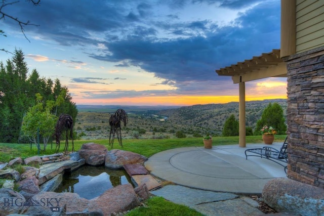 1061 Lookabout Ln, Manhattan, MT 59741 - yard at dusk with a mountain view and a patio