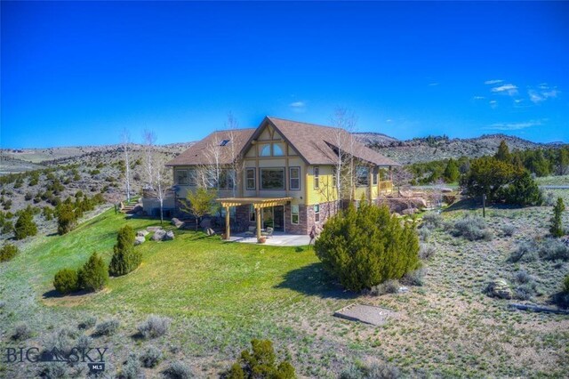 1061 Lookabout Ln, Manhattan, MT 59741 - rear view of house with a patio, a lawn, a mountain view, and a pergola