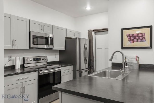 kitchen featuring gray cabinets, sink, and stainless steel appliances