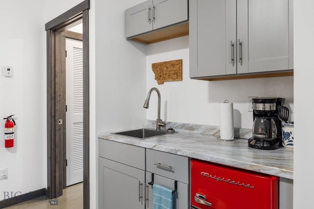 kitchen with gray cabinetry and sink