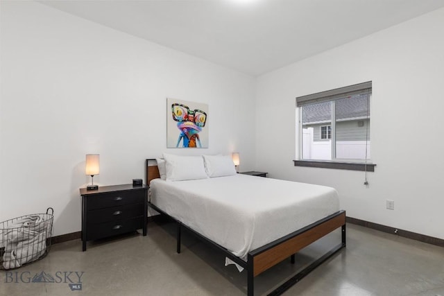 bedroom featuring concrete flooring