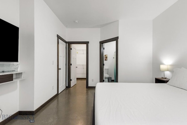 bedroom featuring a spacious closet, a closet, and ensuite bathroom