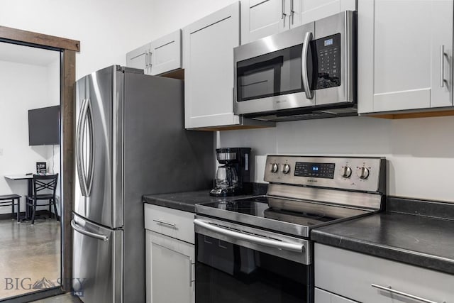 kitchen featuring appliances with stainless steel finishes and white cabinetry