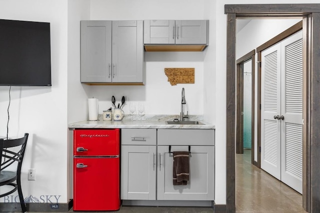 bar featuring gray cabinets and sink