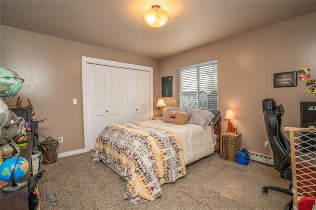 bedroom with carpet, baseboard heating, and a closet