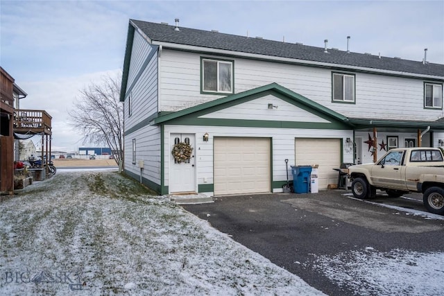 rear view of property with a garage