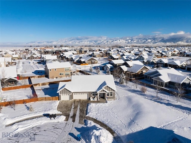 snowy aerial view featuring a mountain view