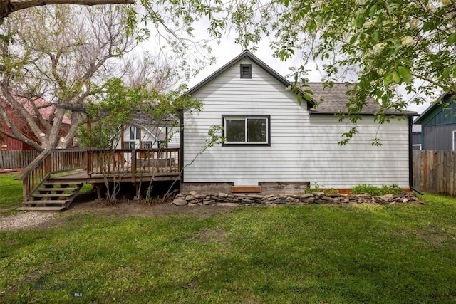 back of property featuring a lawn and a wooden deck