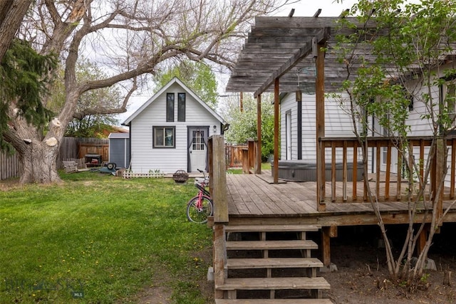 exterior space with a deck, a pergola, a yard, and a hot tub