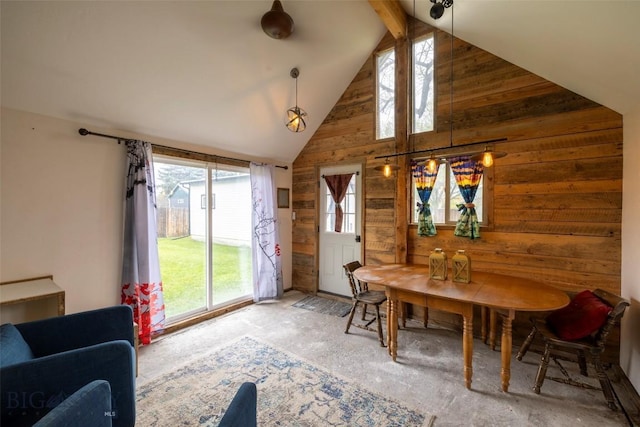 sunroom with vaulted ceiling with beams and a healthy amount of sunlight