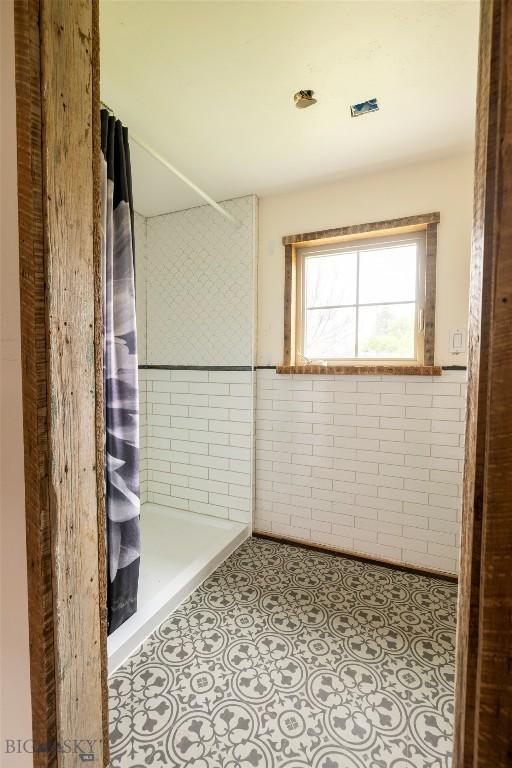 bathroom with tiled shower