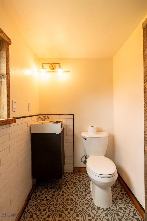 bathroom featuring tile patterned flooring, vanity, and toilet