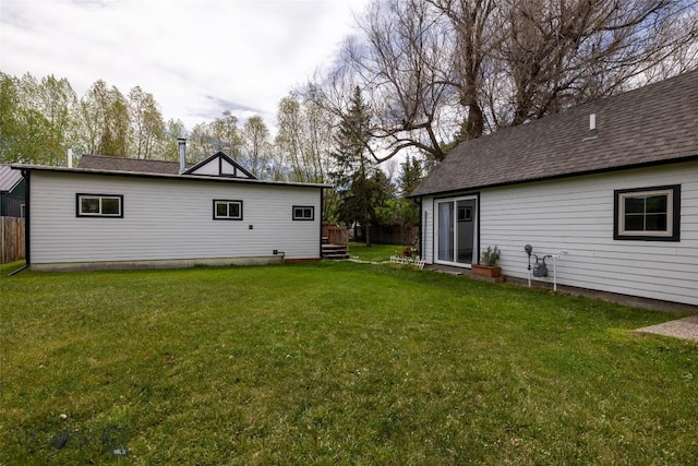 rear view of house with a lawn