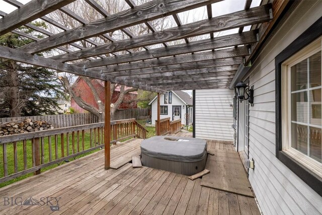 deck with a pergola and a lawn